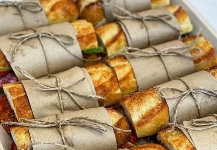 Colorful springtime garden picnic setup with blankets, food, and decorations.